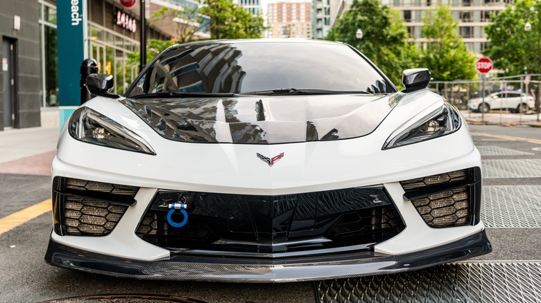 Front end of a white Corvette Z06 parked on a city street