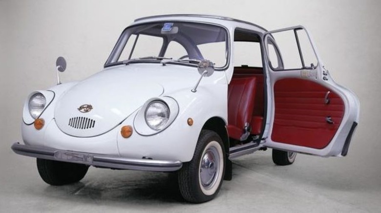 A 1968-1969 Subaru 360 with open suicide door.