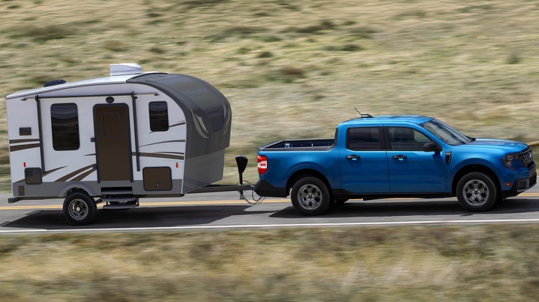 The 2025 Ford Maverick In Blue Pulling A Small Trailer