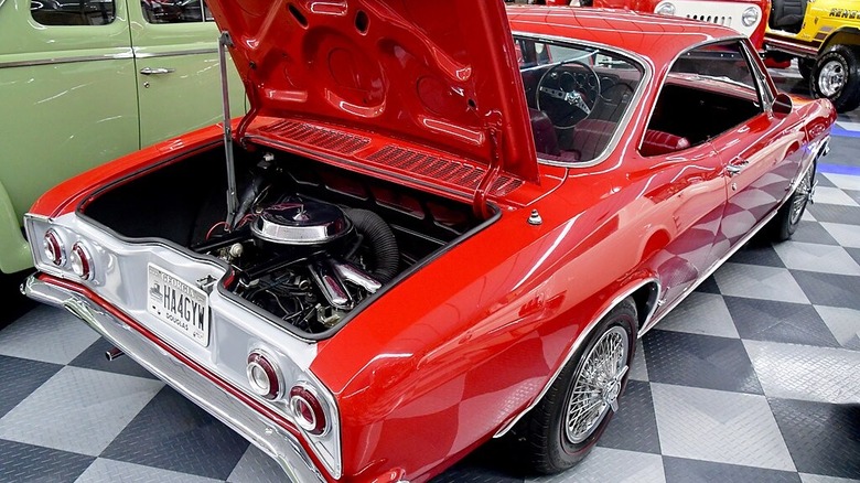 A shot from the rear with hood open on a red 1965 Chevrolet Corvair.