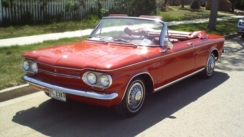 A red Chevrolet Corvair convertible.