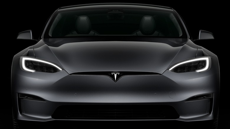 A Tesla Model S Front View In Black Against Dark Background