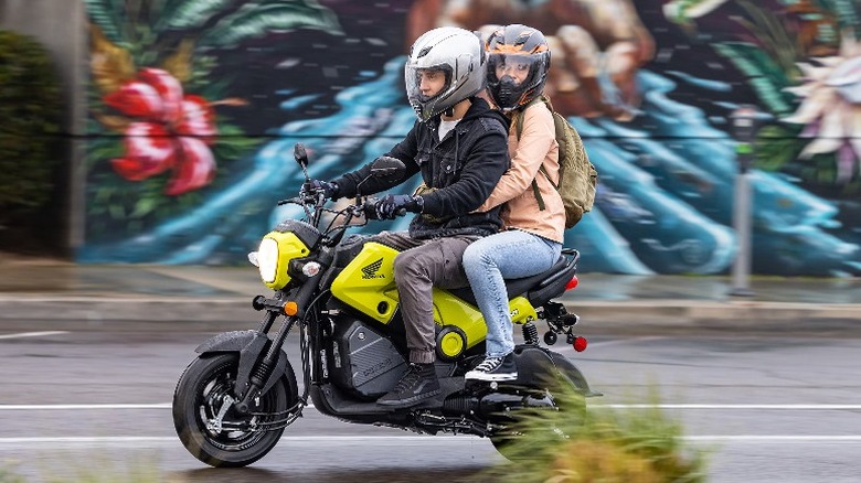 Two people riding Honda Navi