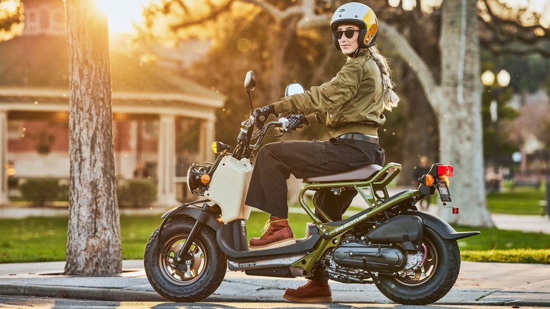 Woman Sitting on a Honda Ruckus scooter