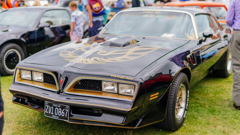 Pontiac Firebird parked on the grass at a car show