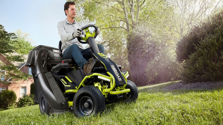 person riding Ryobi lawn mower