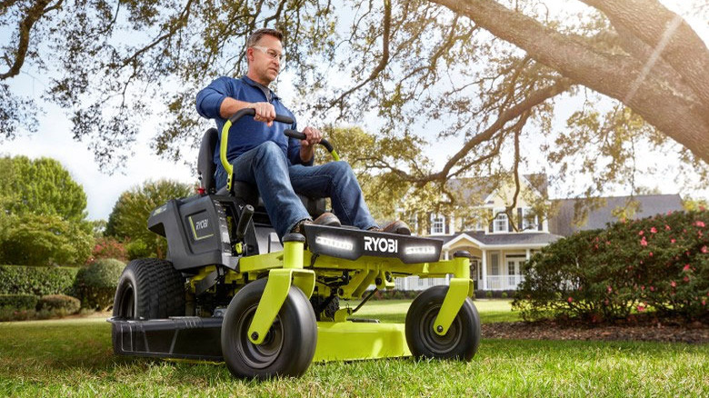 person riding on Ryobi lawn mower