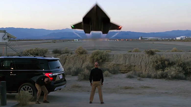 Rear Admiral Chester "Hammer" Cain stands as the Darkstar jet flying overhead in "Top Gun: Maverick"