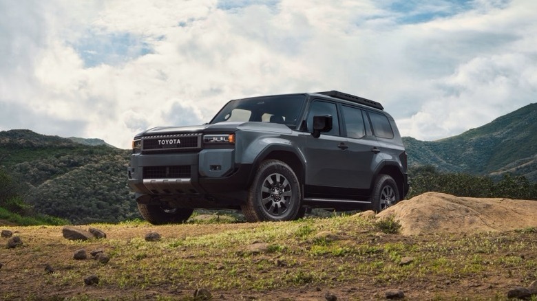 2025 Toyota Land Cruiser parked off-road with mountains behind it