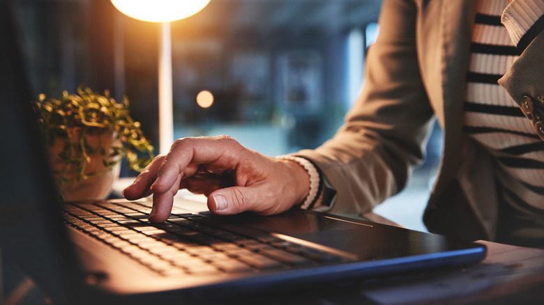 woman typing on laptop keyboard