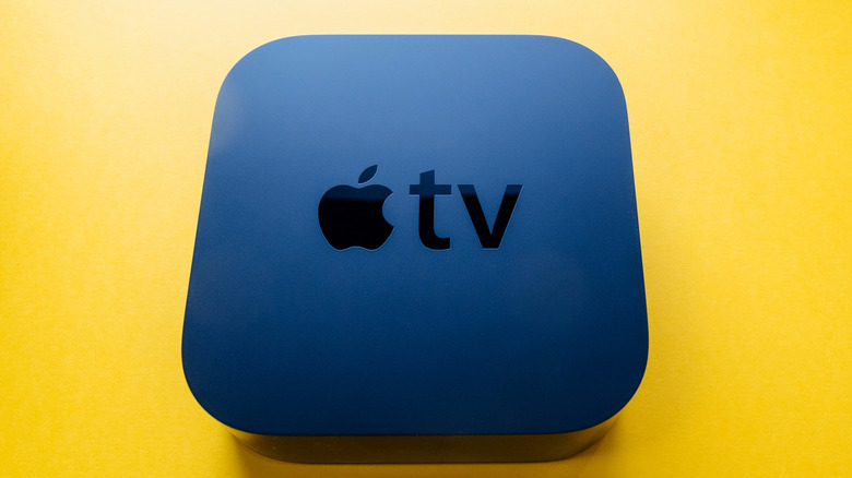 Apple TV device on yellow background