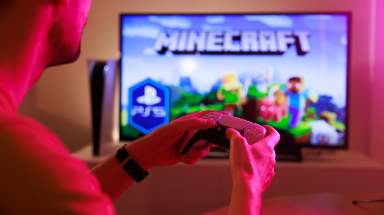 Man playing Minecraft on PS5 and large TV