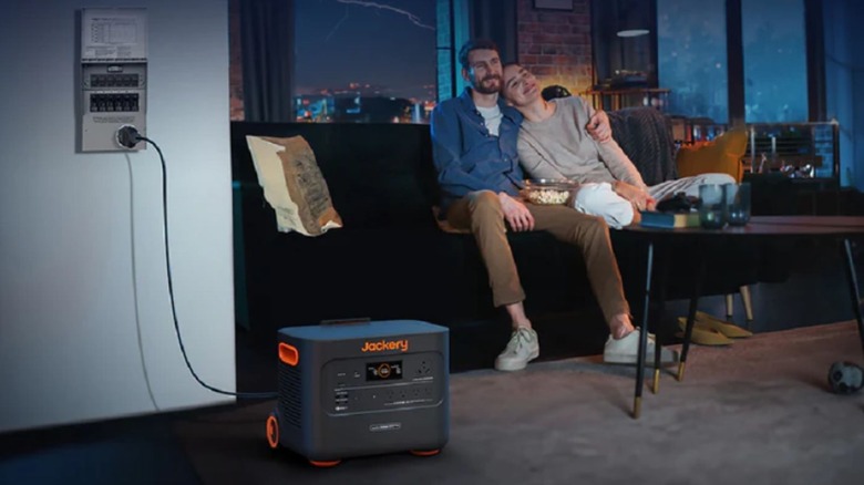 Jackery 3000 Pro plugged into home as couple watches TV