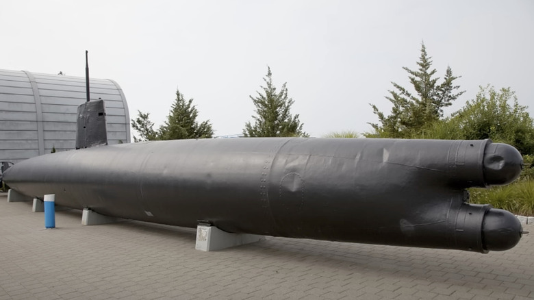 A black submarine at a museum