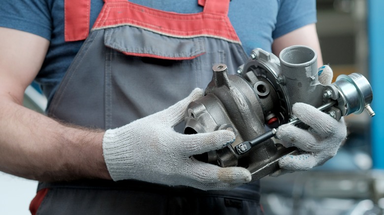 Mechanic holds new turbocharger