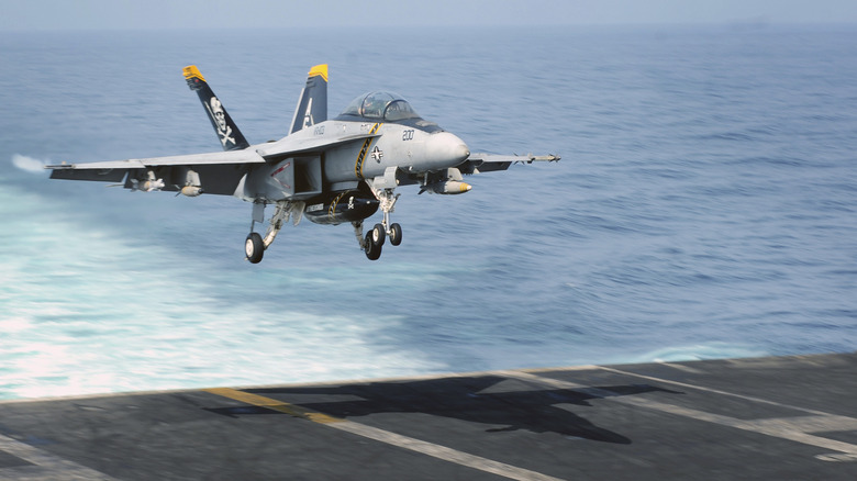 plane landing on aircraft carrier