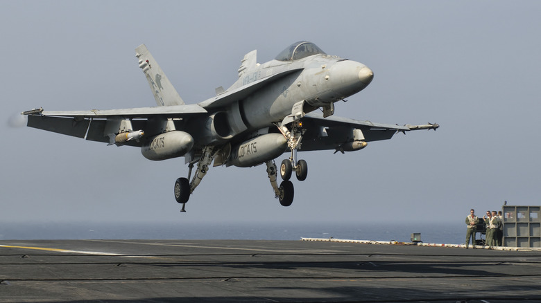 Plane landing on aircraft carrier