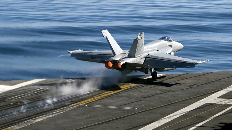 plane taking off aircraft carrier