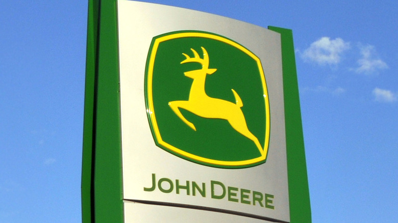 The current green and yellow John Deere logo on a sign.