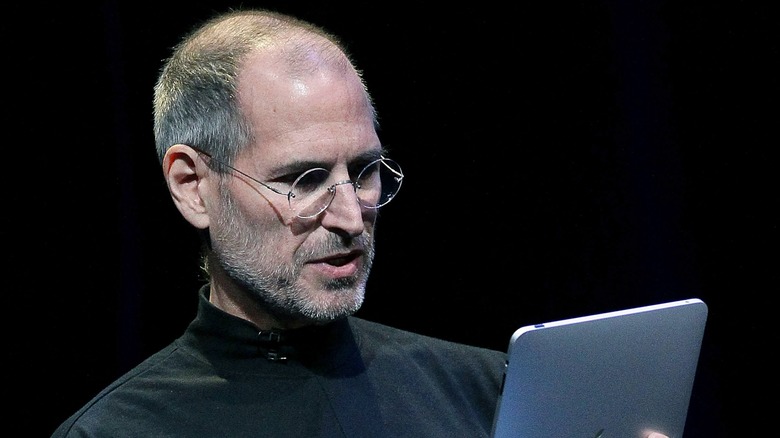 Steve Jobs looking at iPad