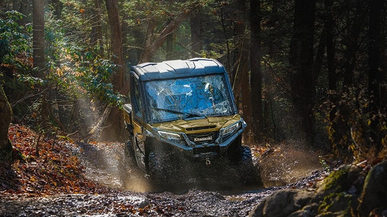 Someone driving a Kawasaki Ridge Limited HVAC through the woods