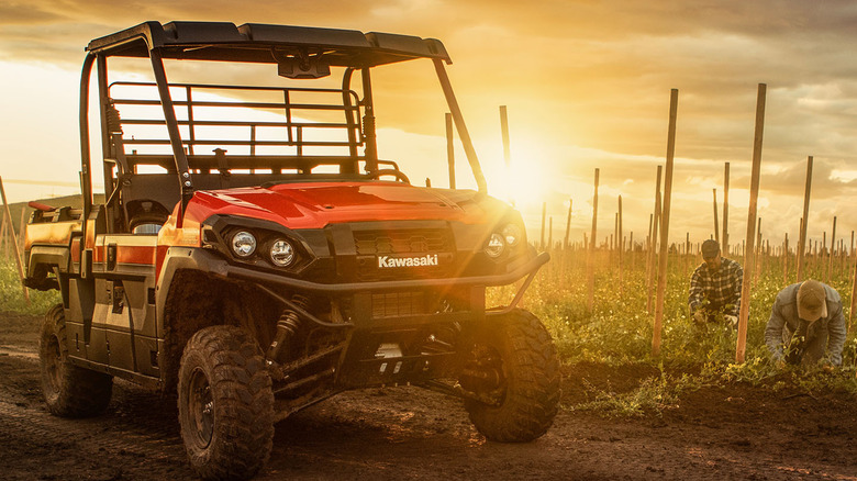 Kawasaki Mule parked next to workers on a farm