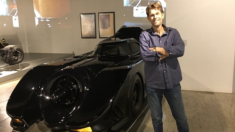 kevin conroy standing with batmobile