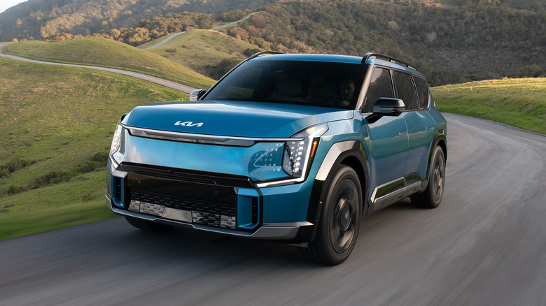 Blue EV9 driving up a mountain