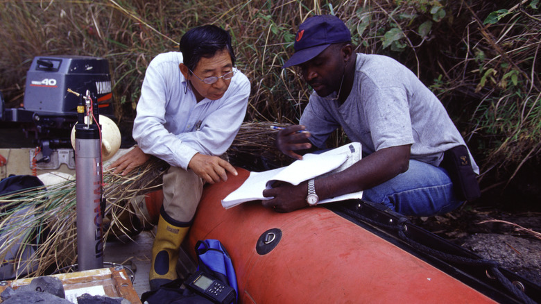 scientists gathering samples from Lake Nyos