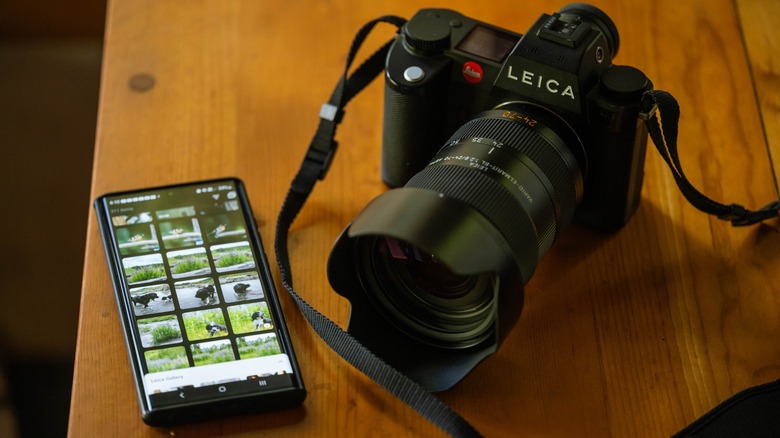 Leica SL3 on table near phone