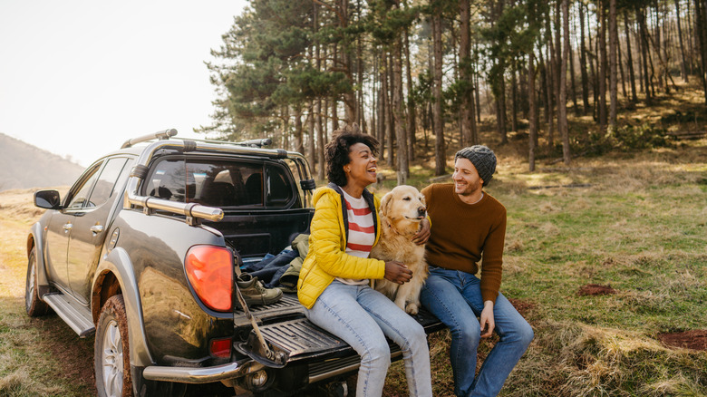 couple camping with truck