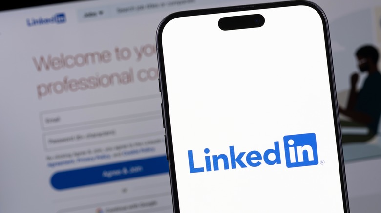 LinkedIn logo on smartphone display and laptop