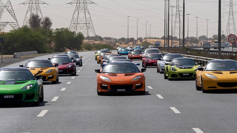 Fleet of Lotus cars driving down the highway