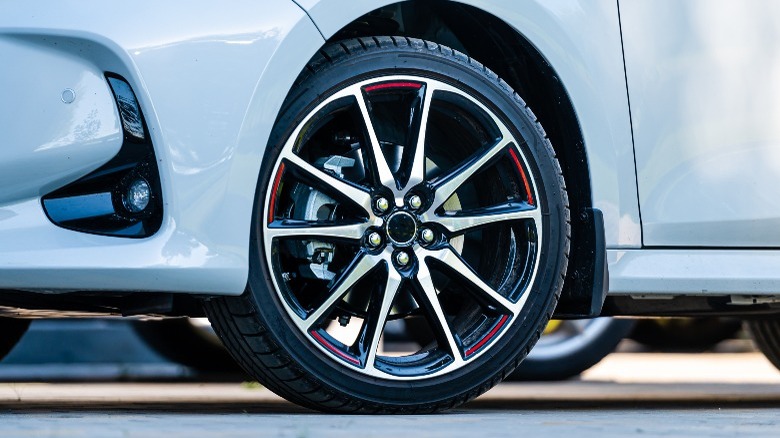 Closeup of low-profile tire on white car