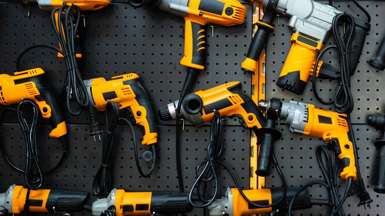 Multiple yellow electric hand drills on display