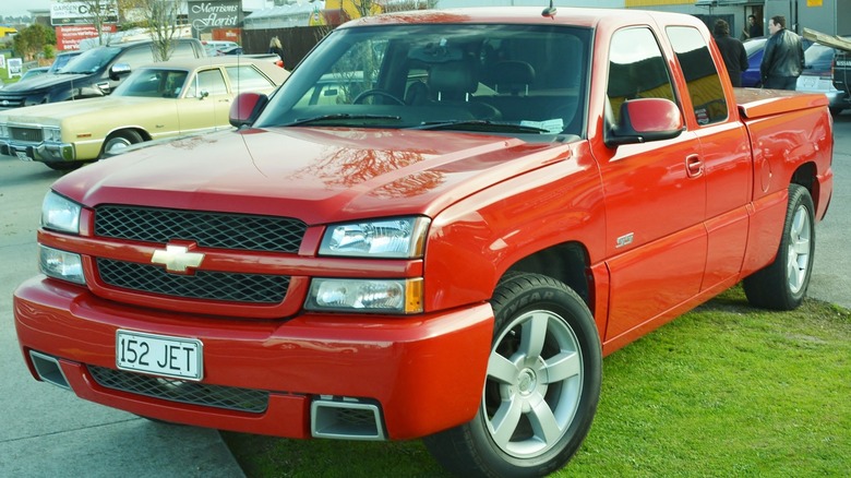 Red Chevy Silverado SS parked on grass