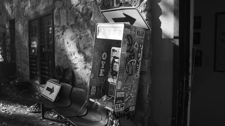 Payphone covered in graffiti