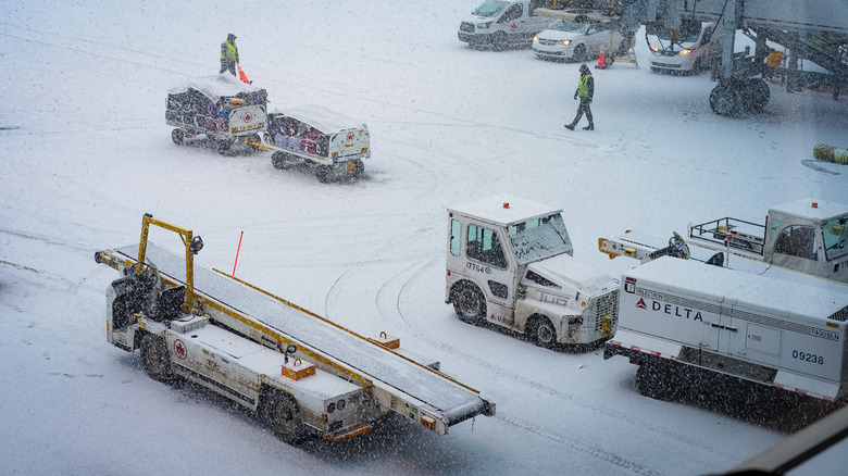 Vehicles in snow at airport