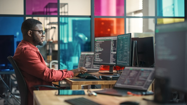 man using multiple monitors