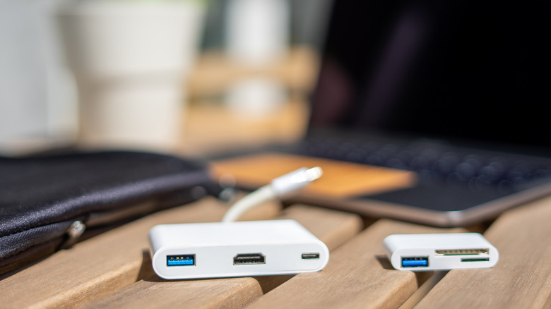 MacBook adapters on table next to laptop