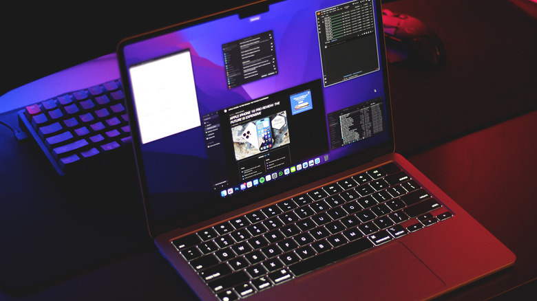 MacBook on a desk with several apps open