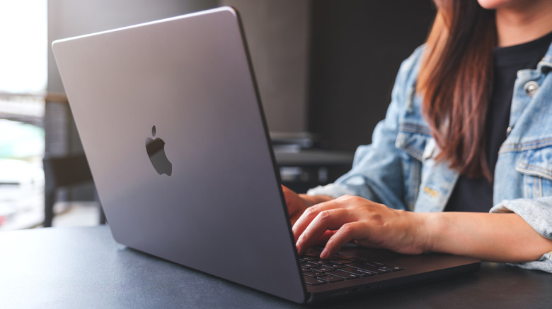 close-up of woman using a Mac