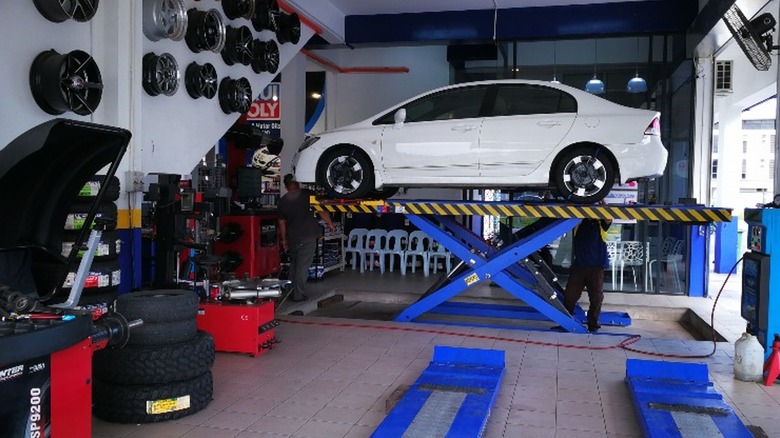 A white Honda Civic on a raised platform