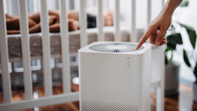 Hand touching air purifier