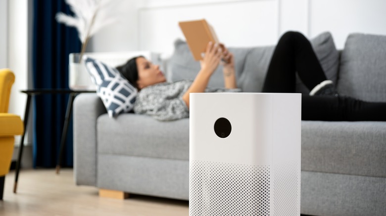 Woman using air purifier