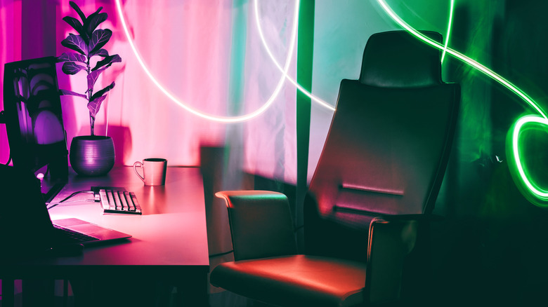 A green and white gaming chair on a purple background.