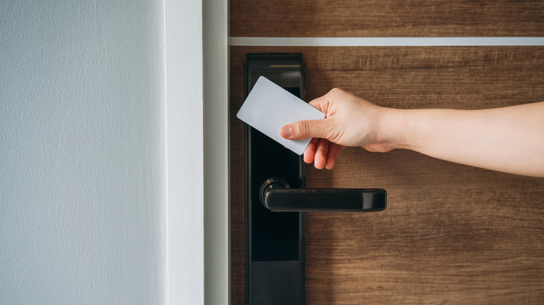 A photo of a person using an NFC card to open a door