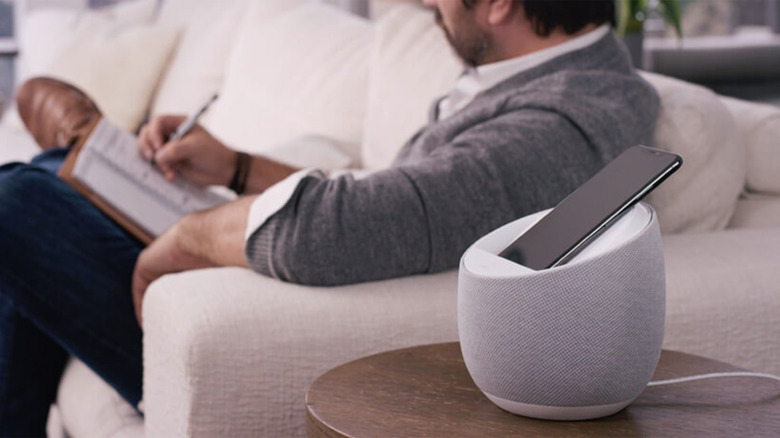 A Belkin Soundform Elite on a table next to a man