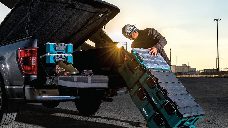 Worker moving Makita MakTrak case