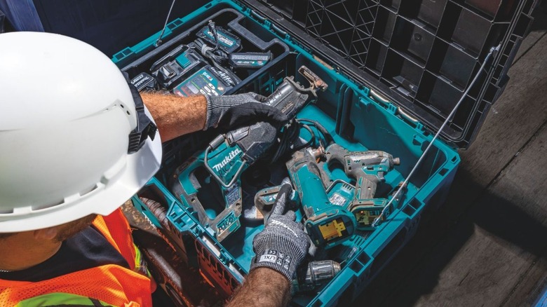 worker going through tools in a toolbox